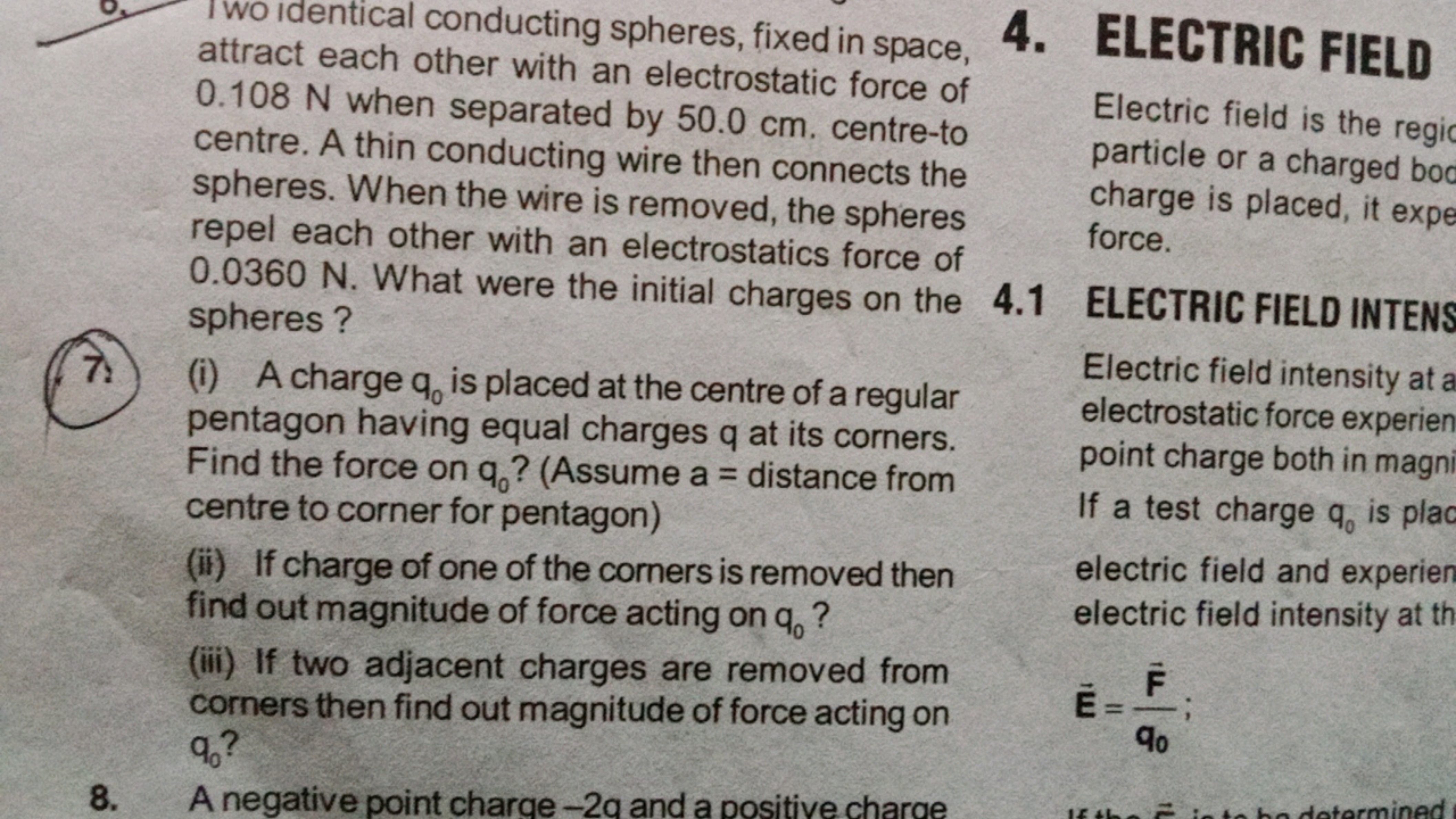 I wo Identical conducting spheres, fixed in space, attract each other 