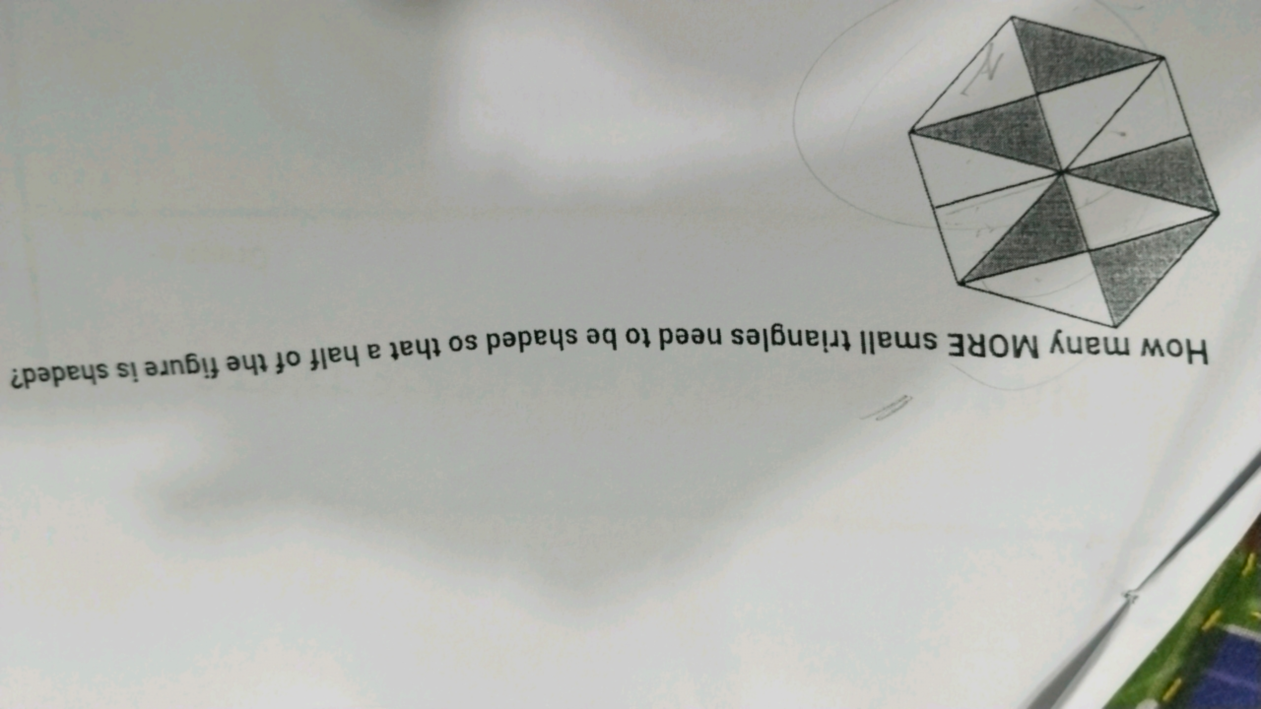 How many MORE small triangles need to be shaded so that a half of the 