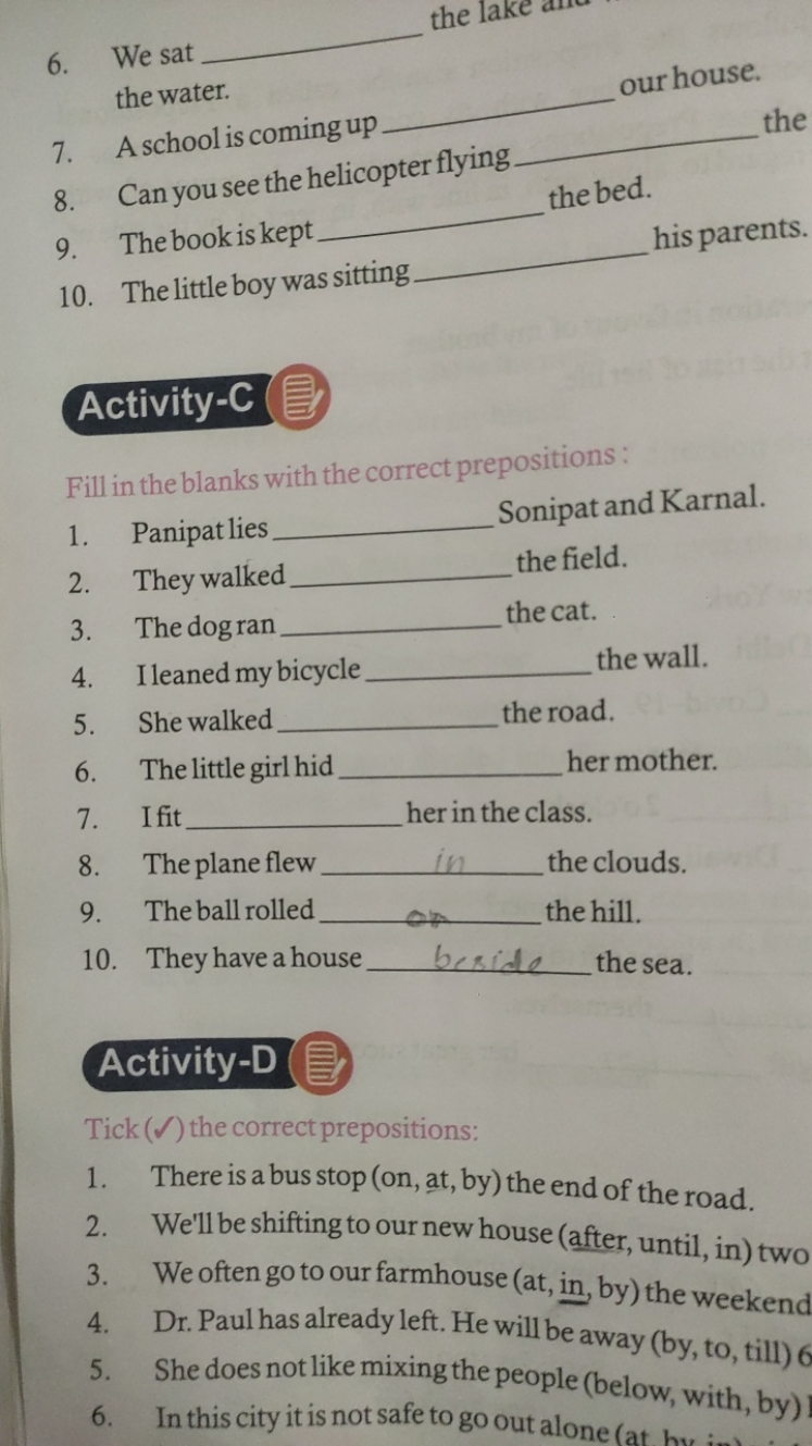 6. We sat  the water.
7. A school is coming up  our house.
8. Can you 