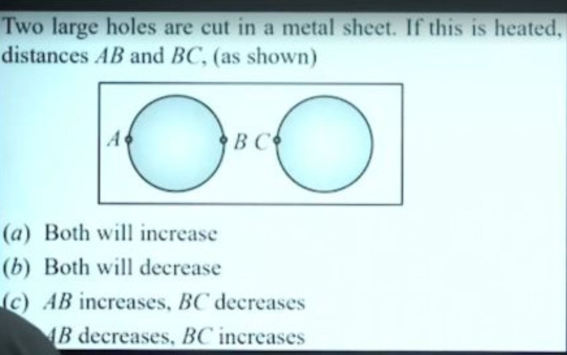 Two large holes are cut in a metal sheet. If this is heated, distances