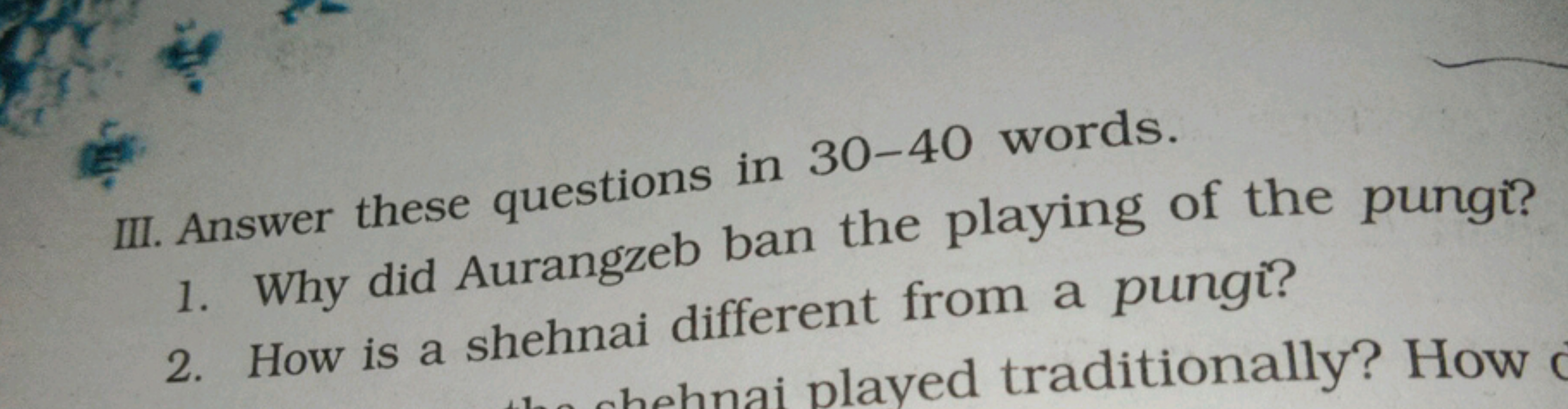 III. Answer these questions in 30-40 words.
1. Why did Aurangzeb ban t