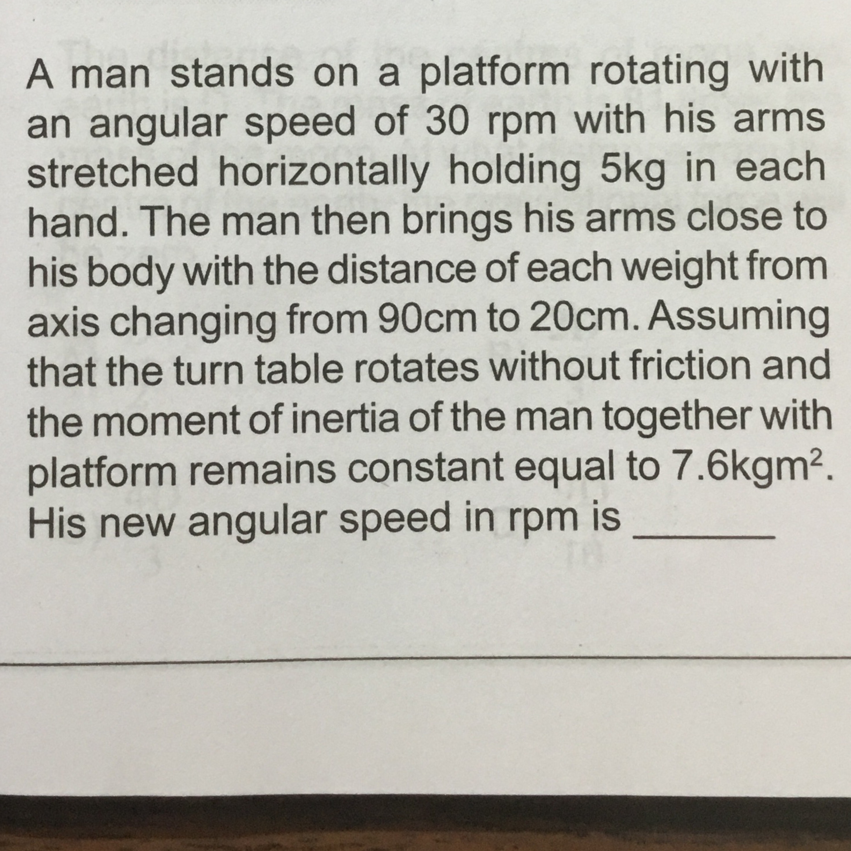 A man stands on a platform rotating with an angular speed of 30 rpm wi