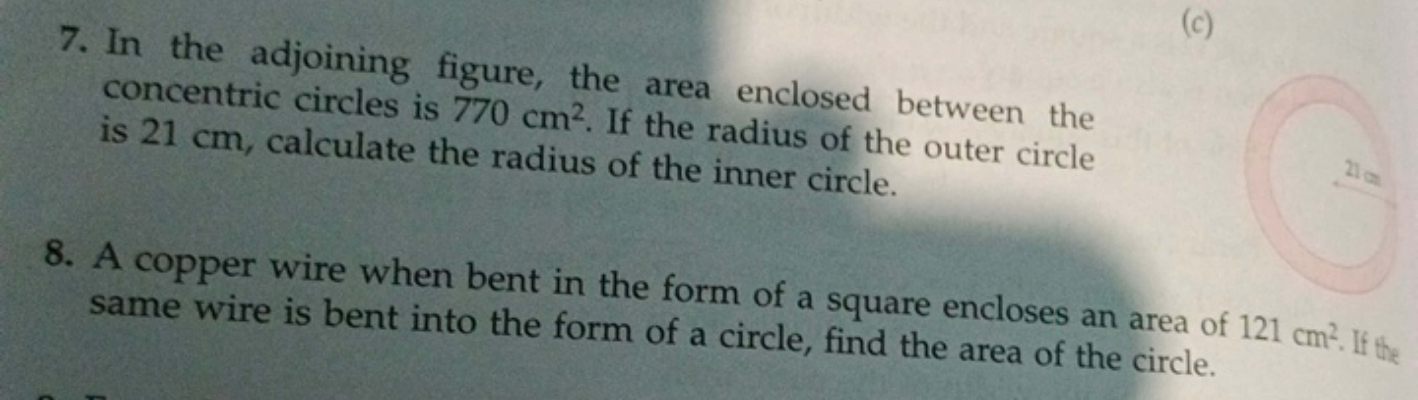 7. In the adjoining figure, the area enclosed between the
concentric c