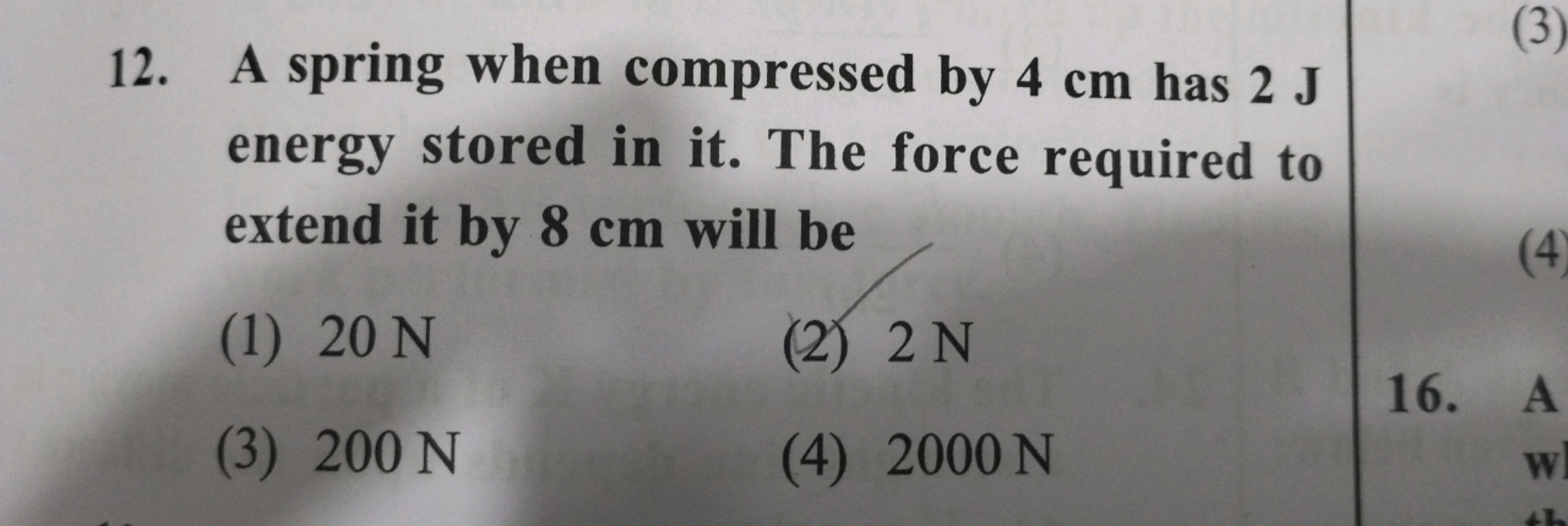 12. A spring when compressed by 4 cm has 2 J energy stored in it. The 