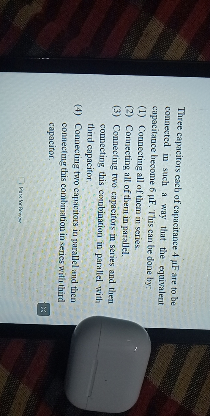 Three capacitors each of capacitance 4μ F are to be connected in such 