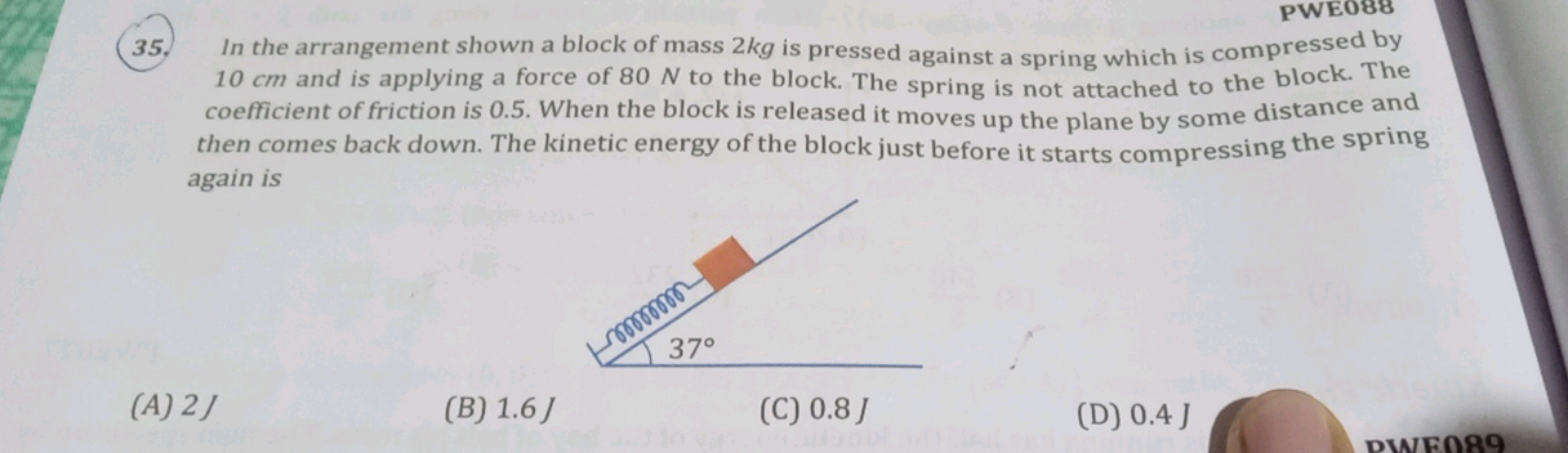 35. In the arrangement shown a block of mass 2 kg is pressed against a