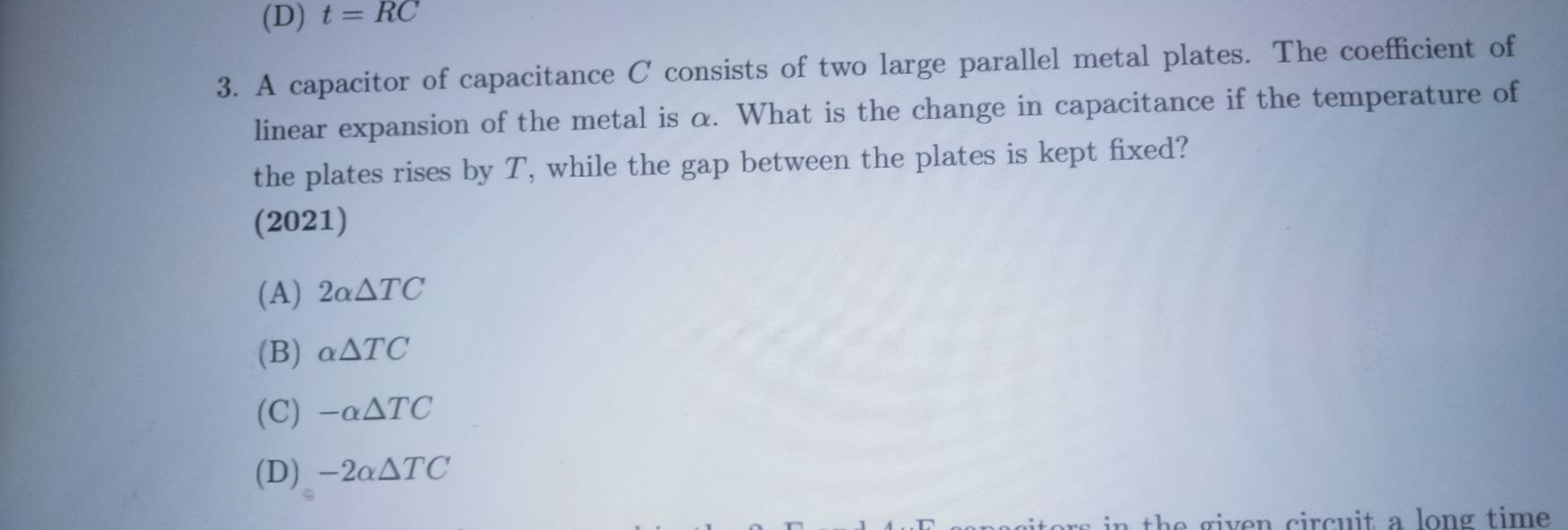 A capacitor of capacitance C consists of two large parallel metal plat