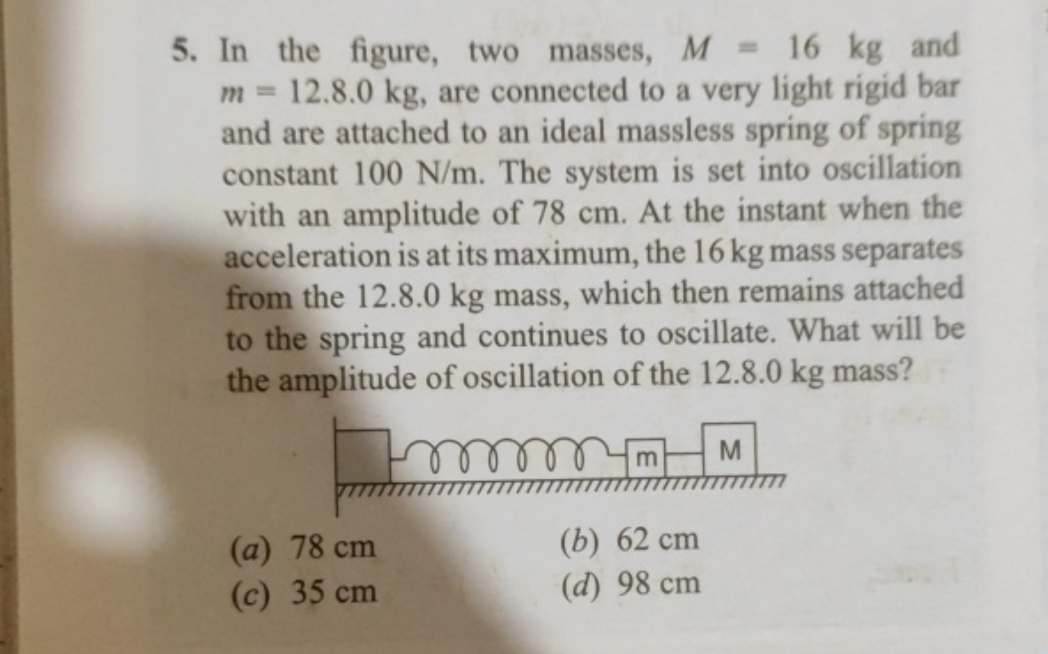 In the figure, two masses, M=16 kg and m=12.8.0 kg, are connected to a