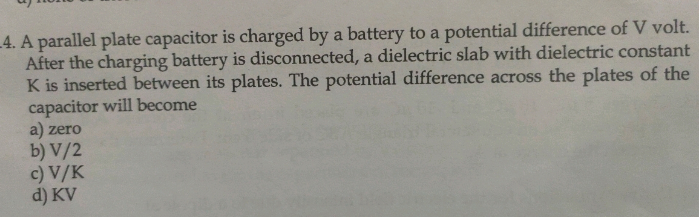 A parallel plate capacitor is charged by a battery to a potential diff