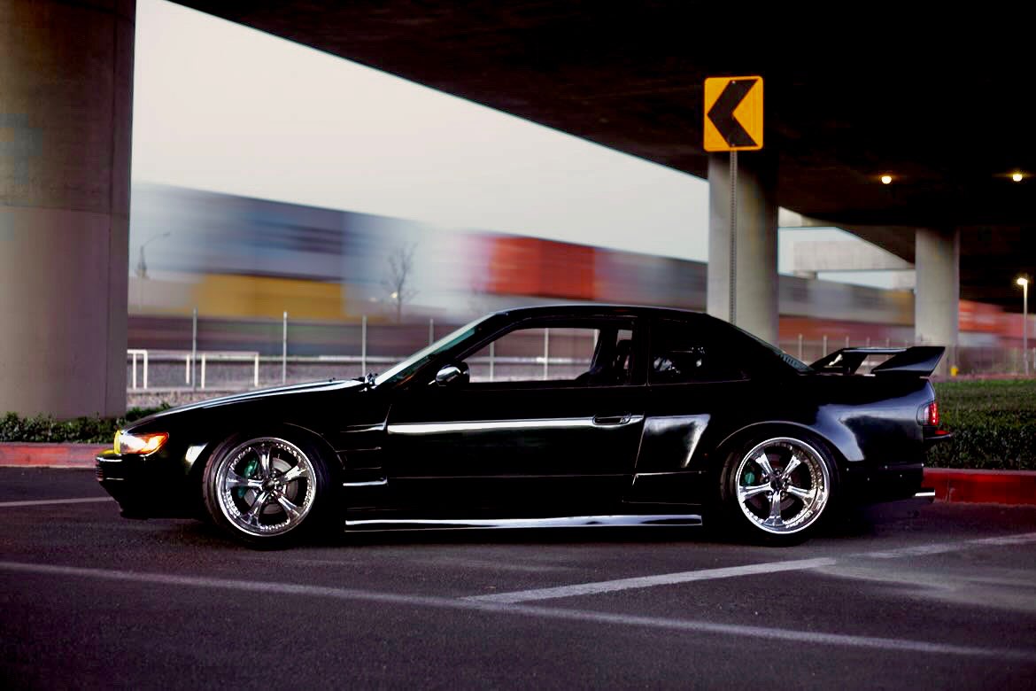 Black 1989 Nissan 240SX on SSR Courage wheels under an overpass