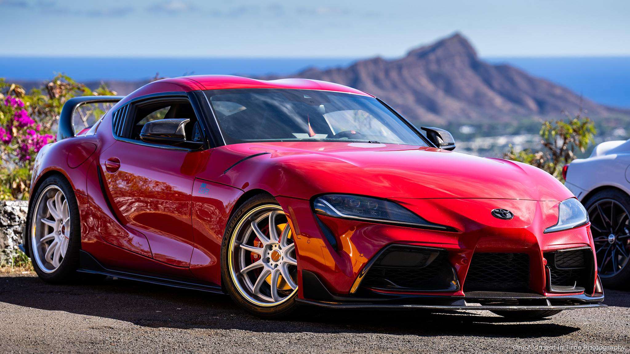 Red 2020 Toyota GR Supra on Work Emotion ZR10 2P wheels with a mountain behind it