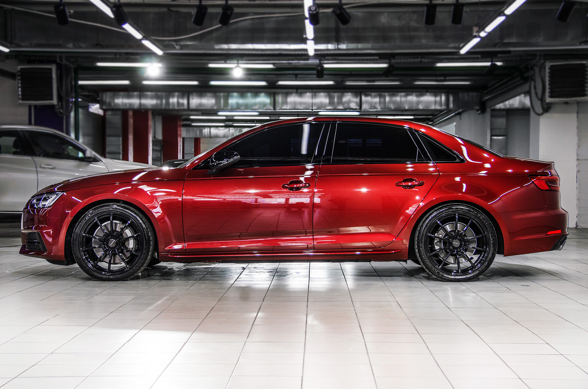 Red Audi A4 on black wheels
