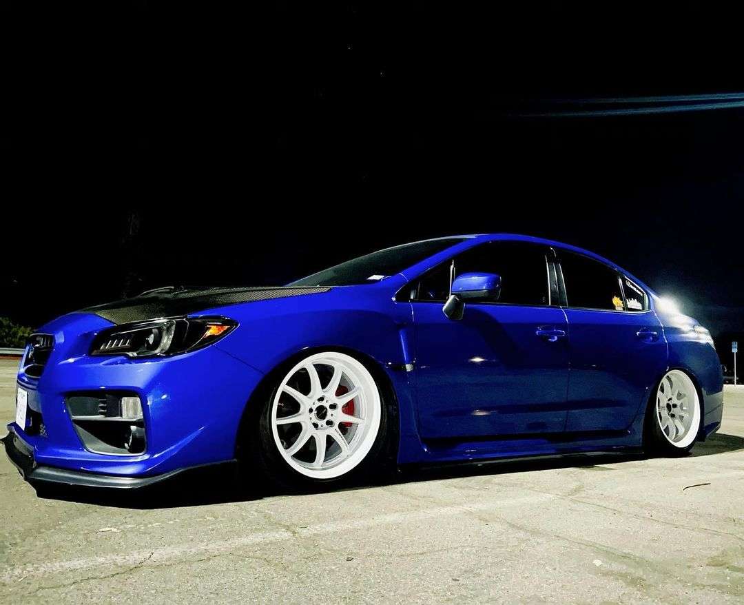 Blue 2017 Subaru WRX on white Work Emotion D9R wheels at night