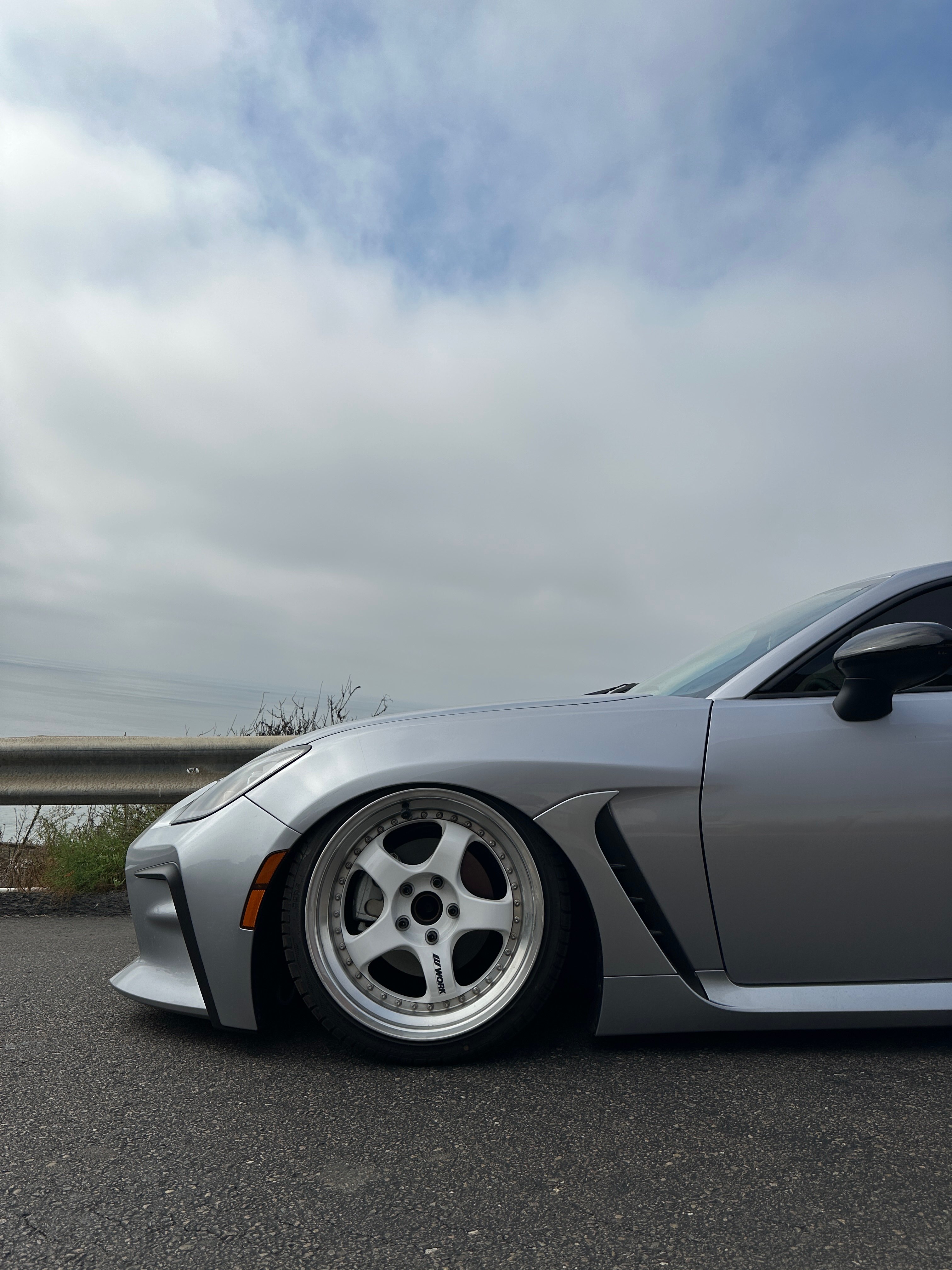 Silver 2022 Toyota GR86 on Work Meister wheels, close-up of the front wheel tucked under the fender