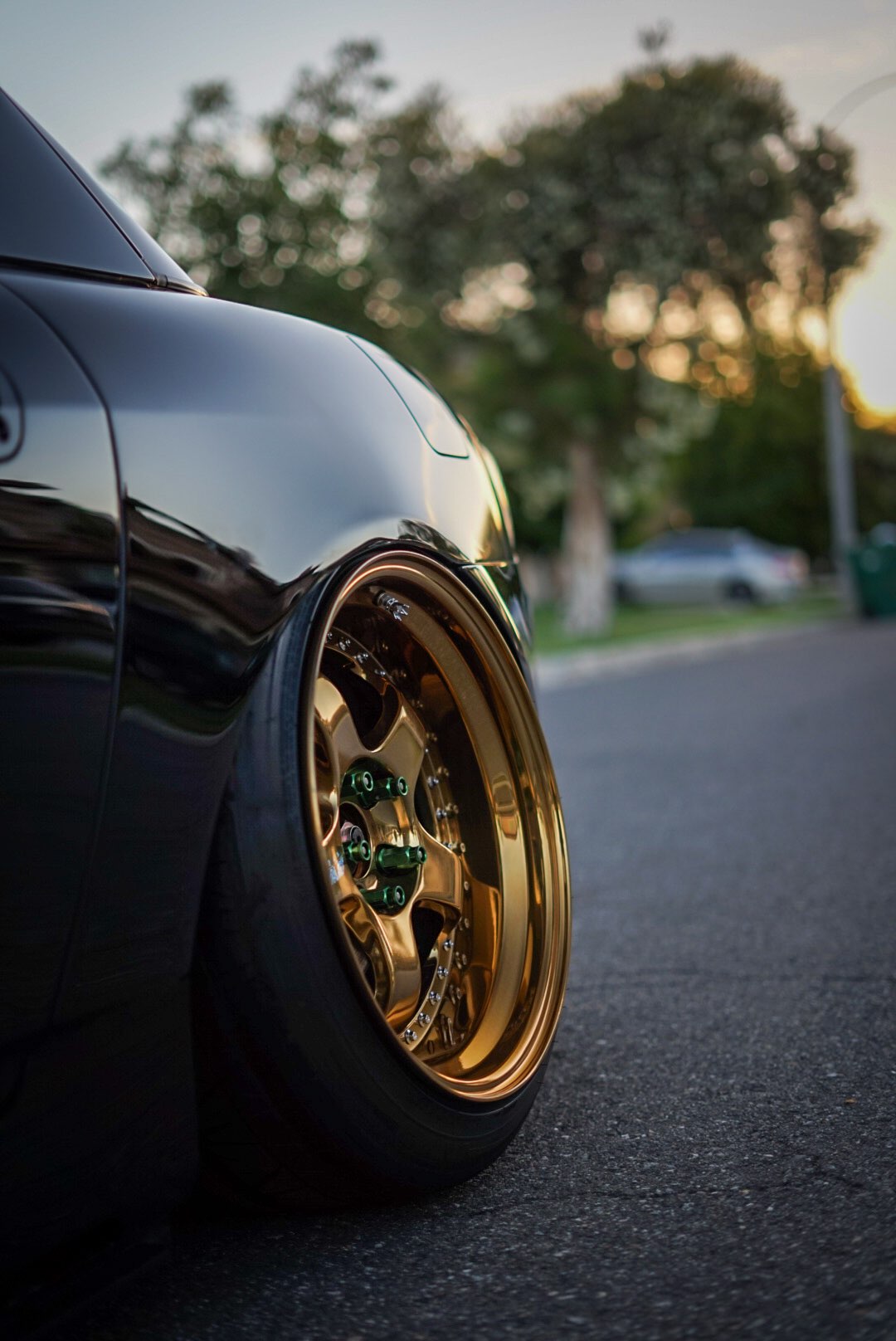 Close-up of a gold Work Meister S1 3-piece wheel on a black 2005 Honda S2000