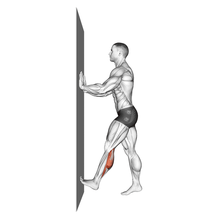 Demonstration of the calf push stretch with hands against wall