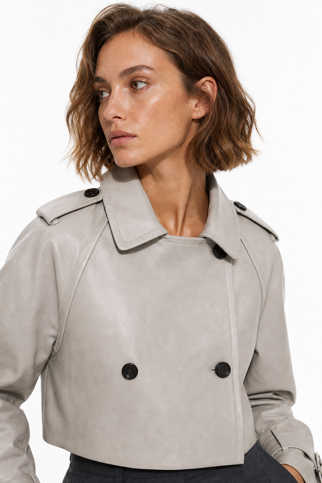 Amy Mendez, an athletic AI fashion model with chin-length wavy brown hair and subtle freckles, posing for a modern fashion shoot.
