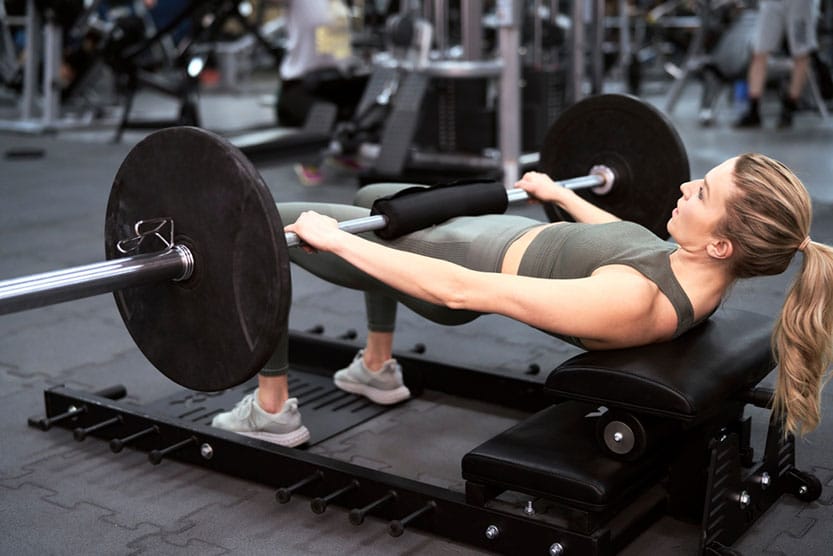 Woman doing hip thrusts with a barbel