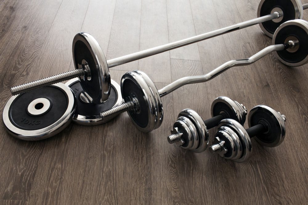 Several dumbbells with different weights on a dumbbell rack