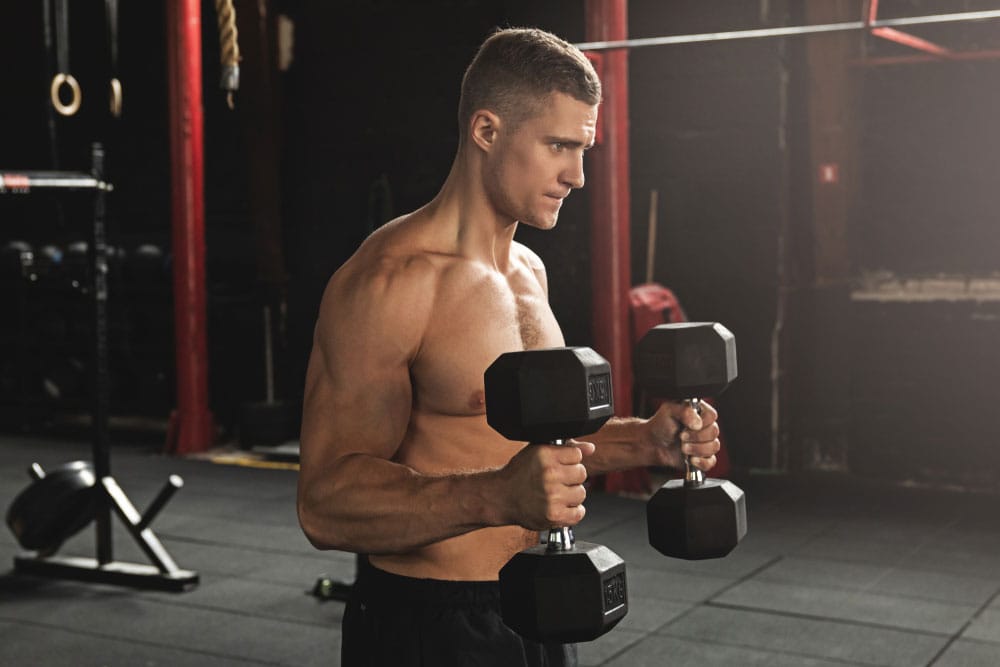 Young man performing hammer curls