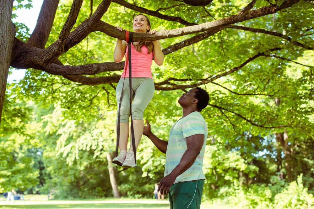 Band assisted pull-ups on a tree