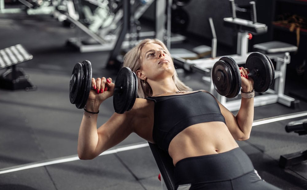 Woman doing incline bench press