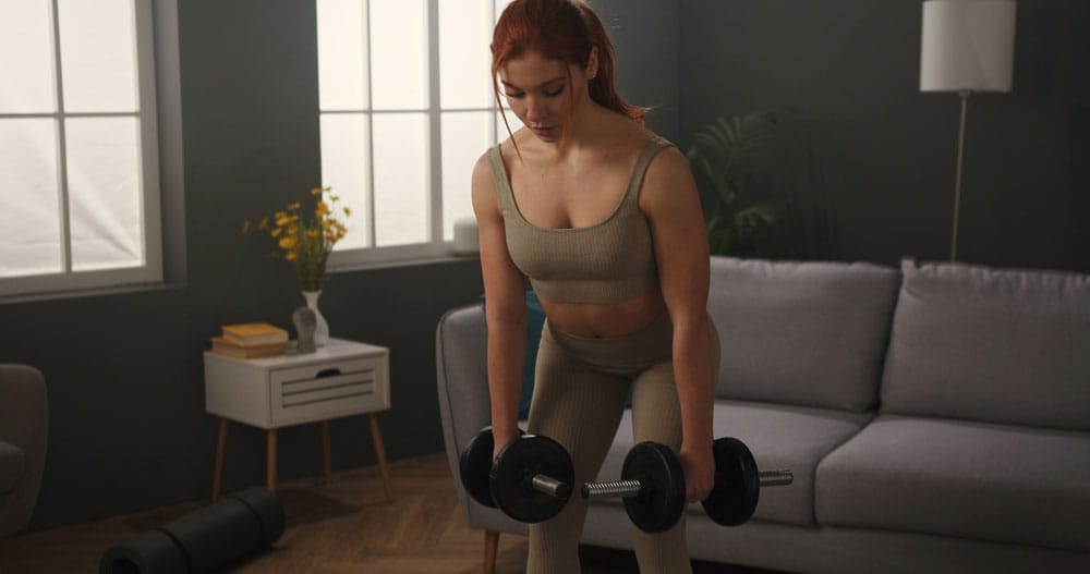 Woman performing a dumbbell deadlift