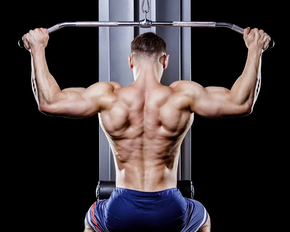 a body builder doing cable back pull down exercise 