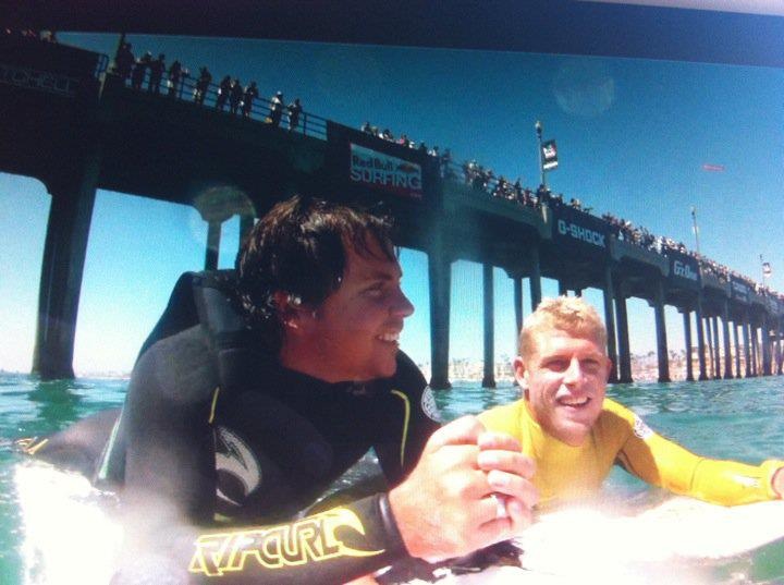 Barney on his surf board, with his friend Mick Fanning.