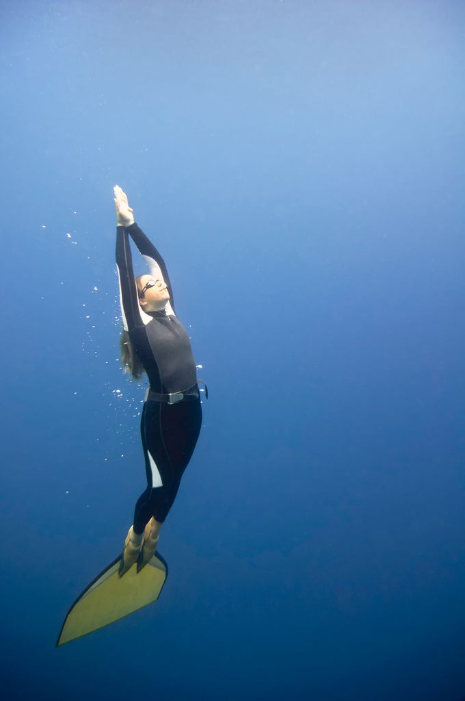 Free diver slowly heading towards surface. Polarizing filter, convenient copy space