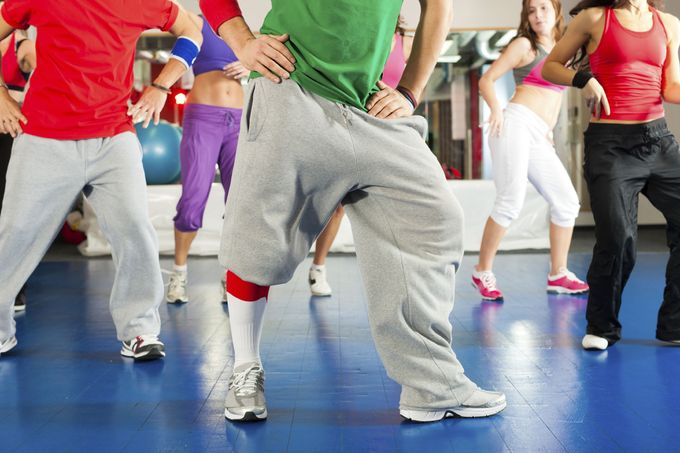 Fitness - Young people doing Zumba training or dance workout in a gym