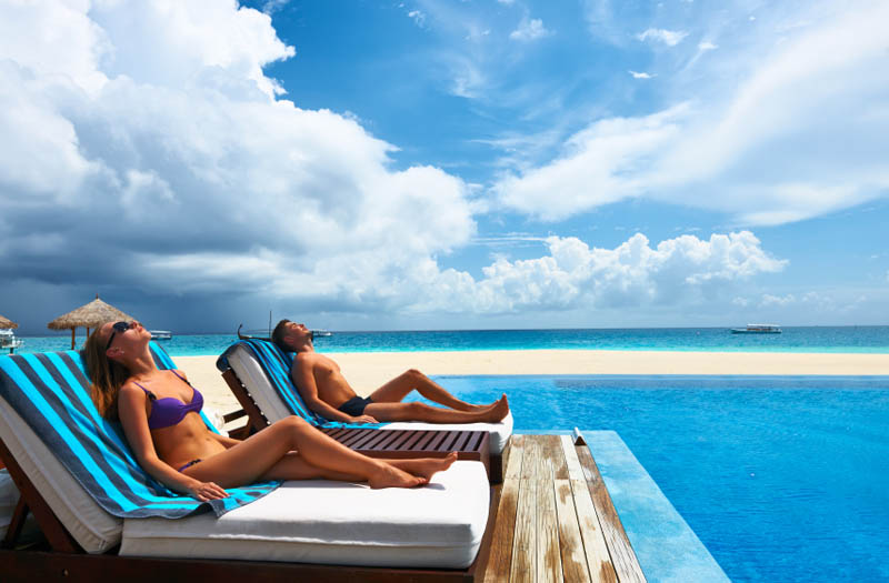 Couple relaxing at the poolside