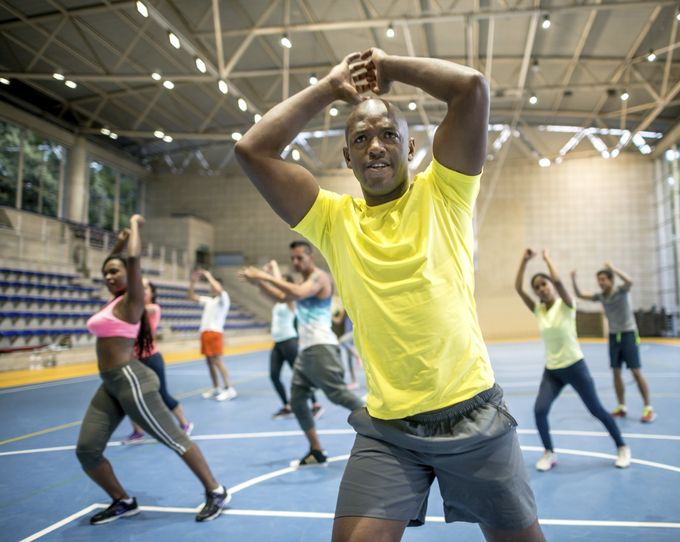 Fit group of people in an aerobics class at the gym - fitness concepts