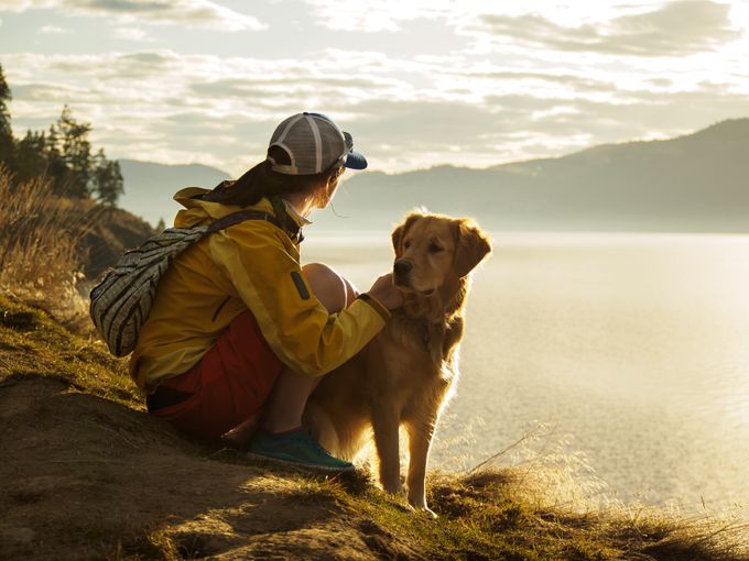 Girl with Golden Retriever on Mountain at Sunset by Lake