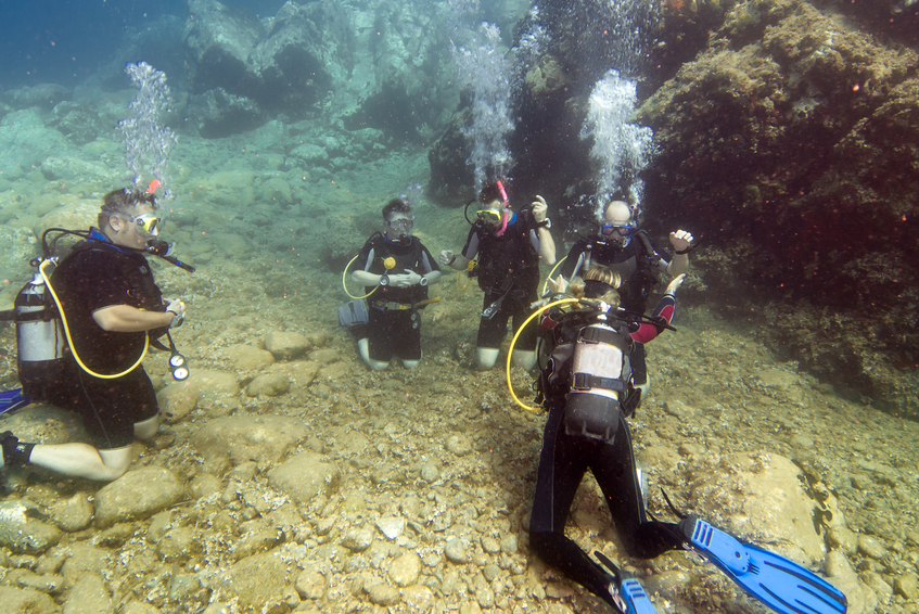 Young men underwater learning to Scuba dive