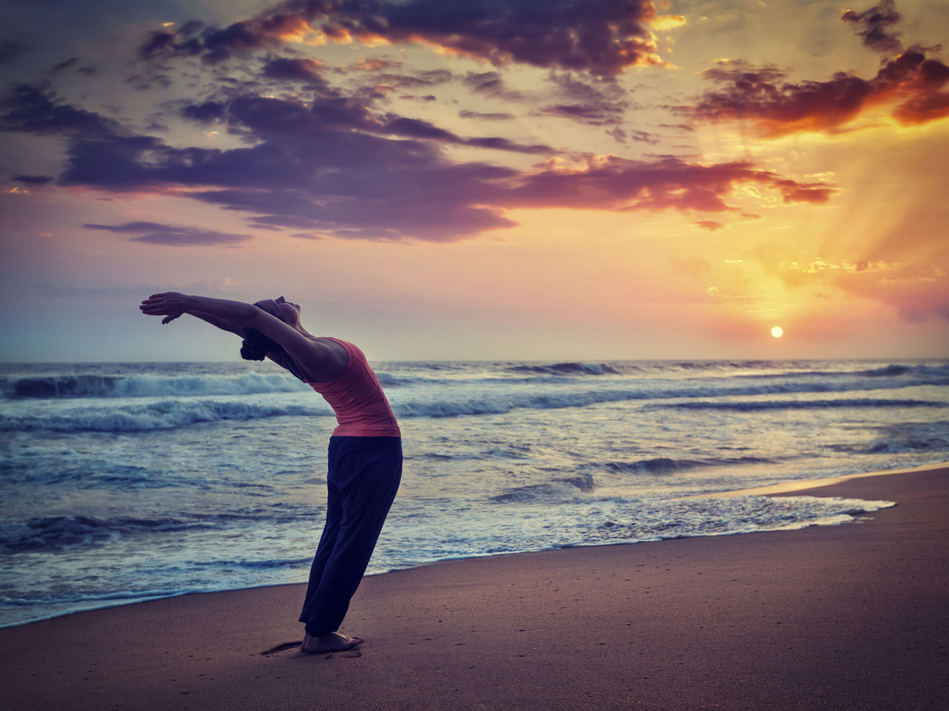 Yoga For Beginners | Everything You Need To Know - Woman Practising Yoga Pose on a Beach