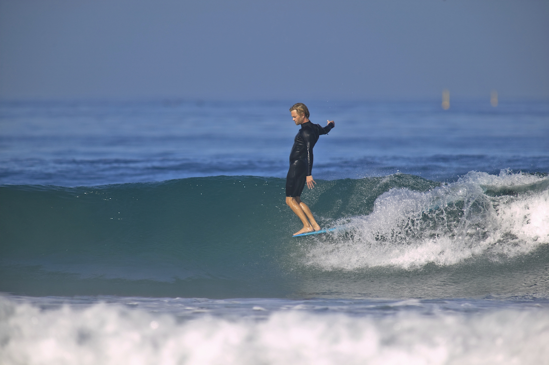 The Best Surfboard For You surfer hangs ten on a longboard