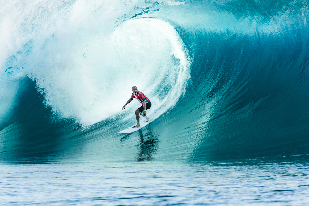 Surfing for Beginners: Surfer Kelly Slater, with GoPro in mouth, Surfing at Teahupoo in Tahiti