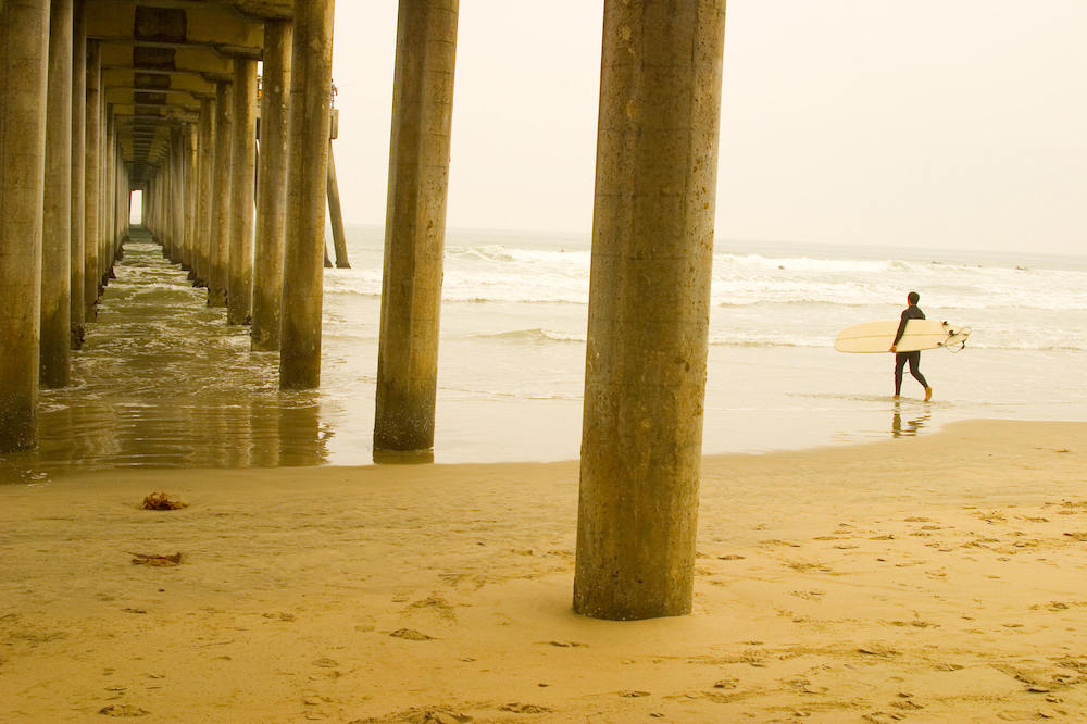 Safe Surfing Tips: surfer next to pier