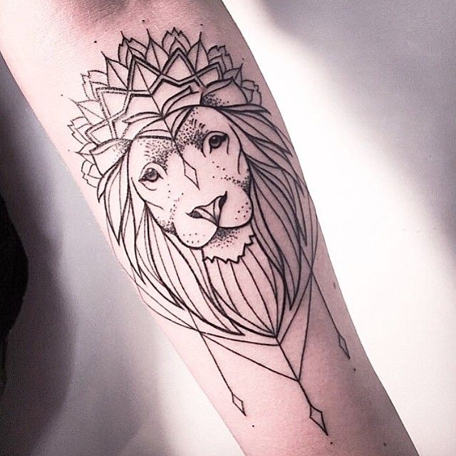 Tiny minimalistic lion portrait tattooed on the wrist.