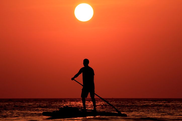 Paddleboarder at sunset