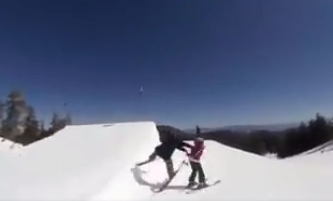 snowpark skier pushing over