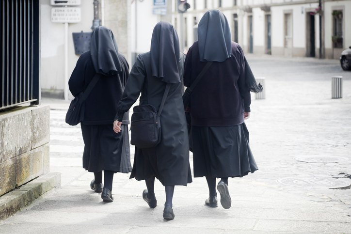 three nuns walking in the street. santiago de compostela