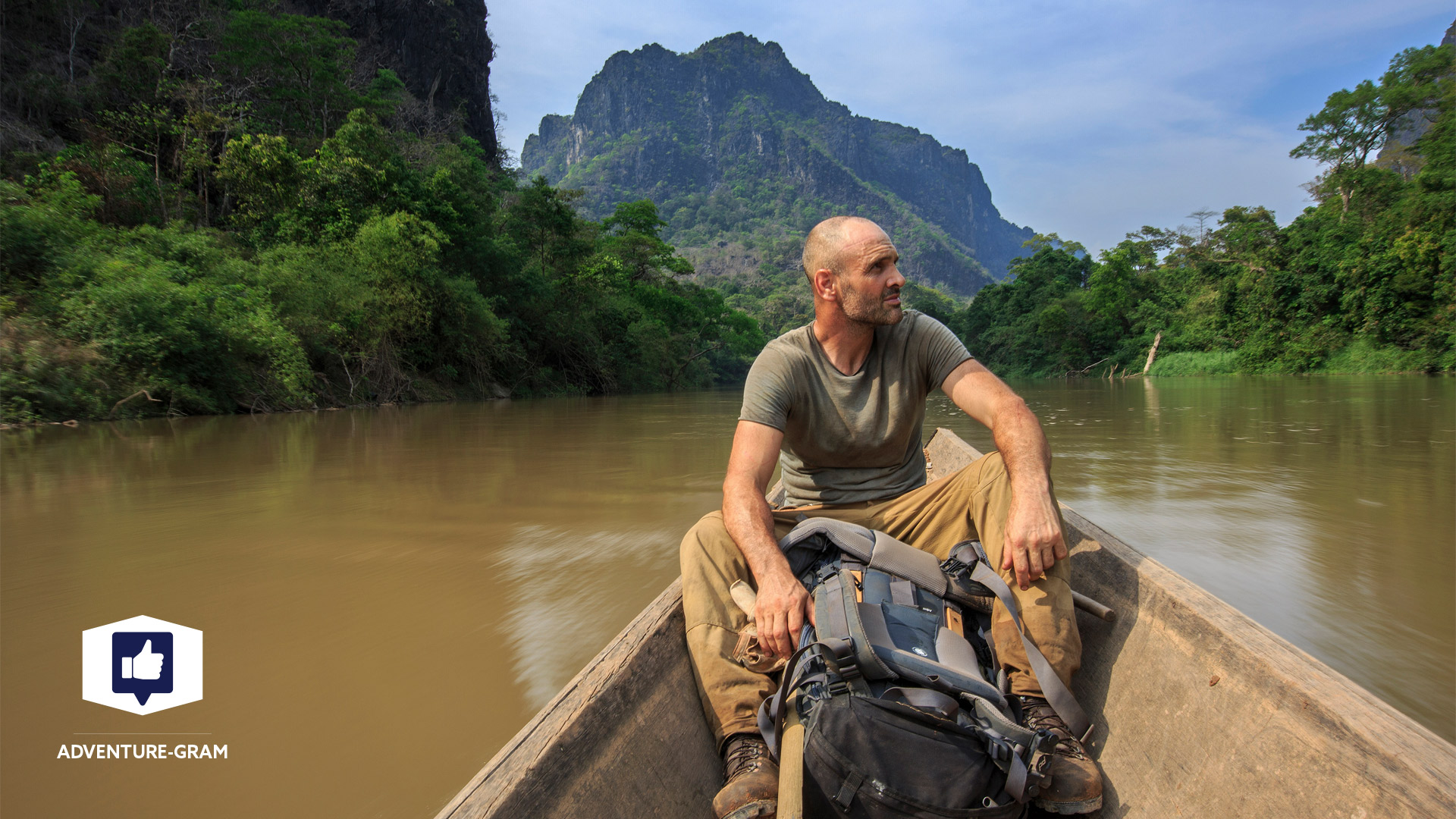 Ed Stafford on a boat going up a river