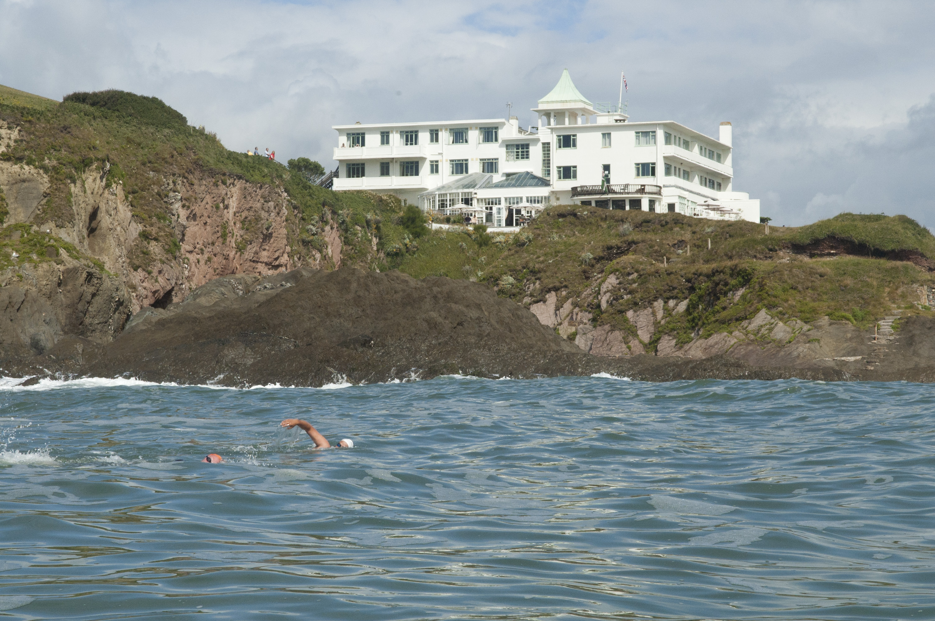 "The front side facing the mainland has a cool-looking art deco hotel, reachable on foot at low tide or by a special water tractor at high tide." Credit: SwimTrek