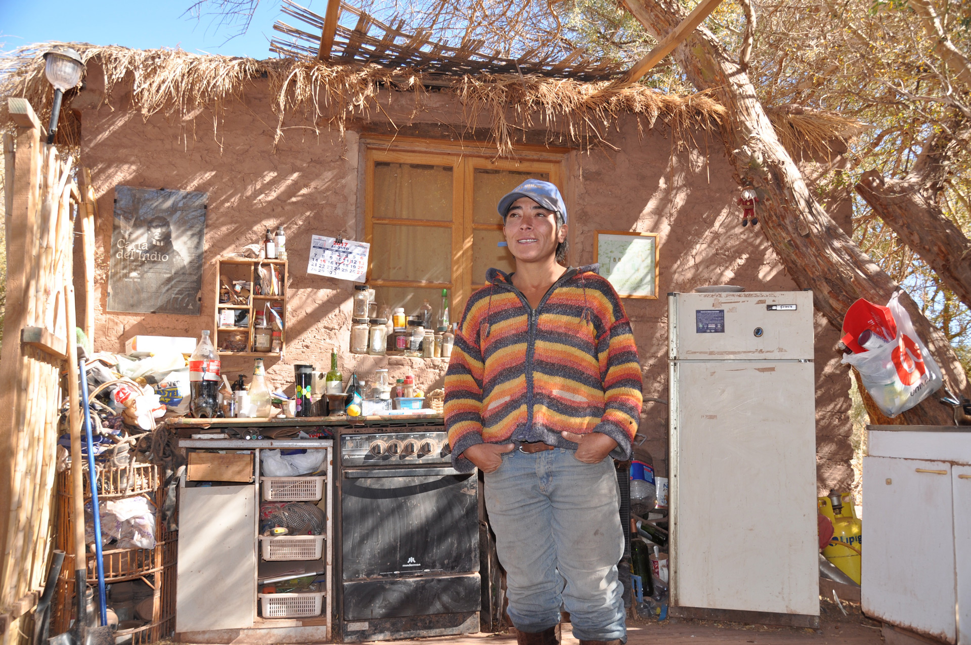 Farmer and water campaigner Karen Luza standing in her outdoor kitchen: her basic home is a stark contrast to the luxury hotels just a few kilometres away