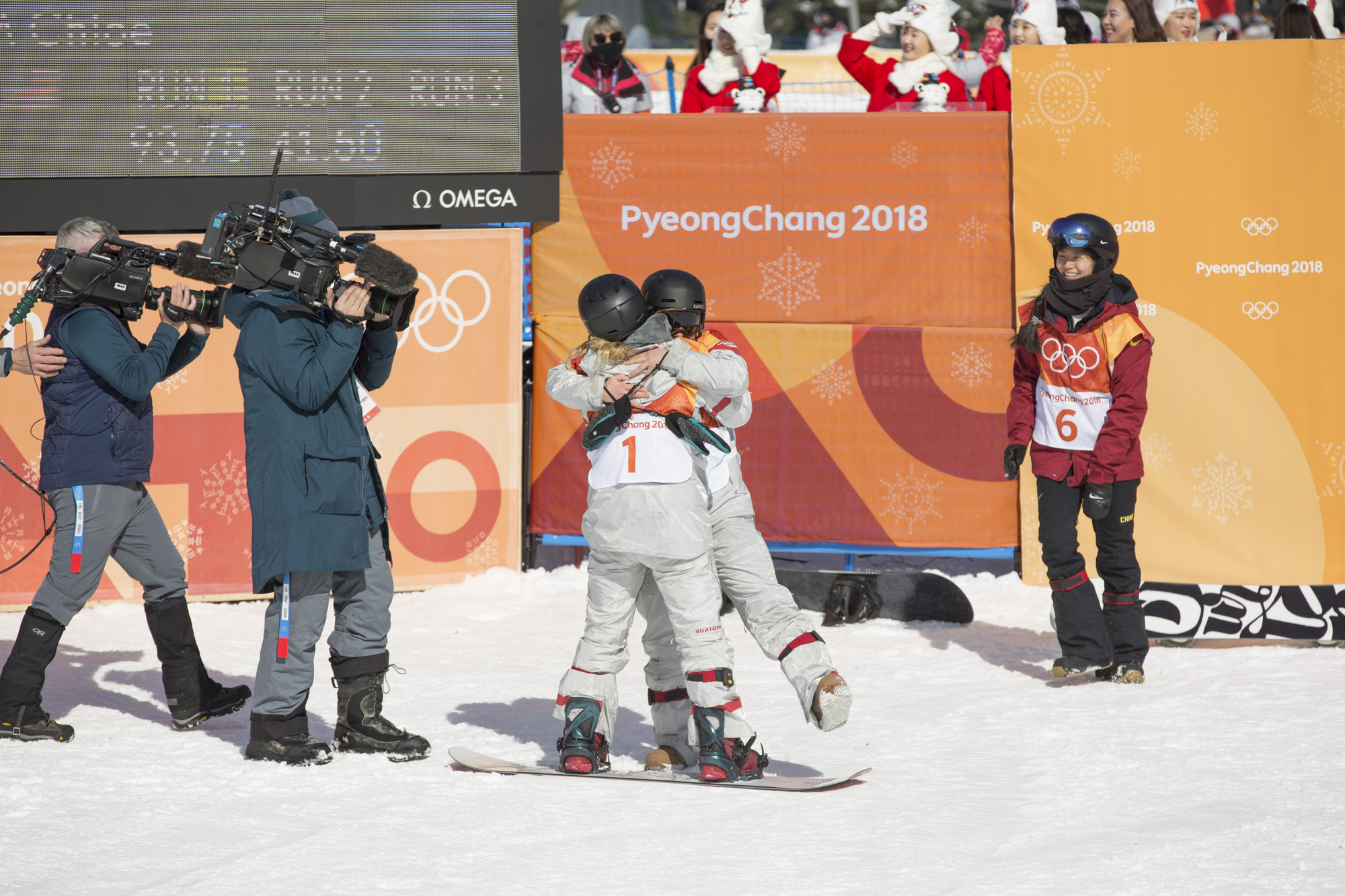 Everybody loves Chloe Kim. Here team-mate (and room-mate out here at the games) Arielle Gold gives her a massive hug as she gets to the bottom of her final run, while China's Jiayu Liu looks on, smiling. Photo: Sam Mellish