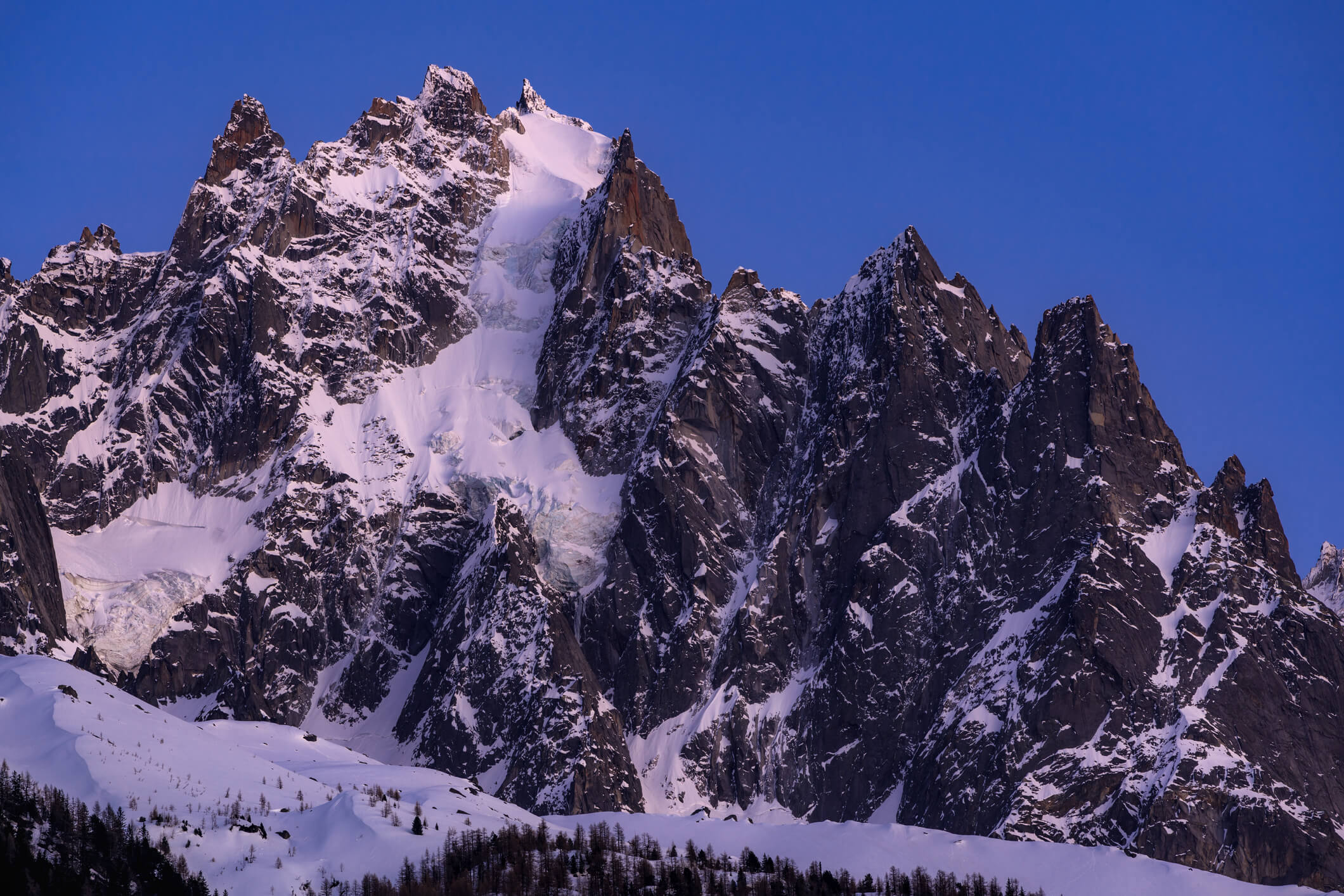 Pictured: The North Face of Aiguille du Plan descends through the hanging glacier in the centre of the photo.