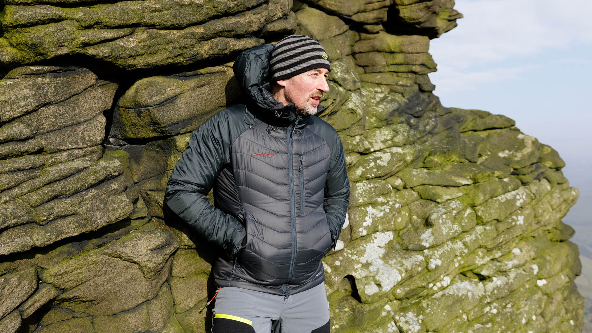 Mammut Rime Pro Hooded Jacket leaning against a gritstone outcrop