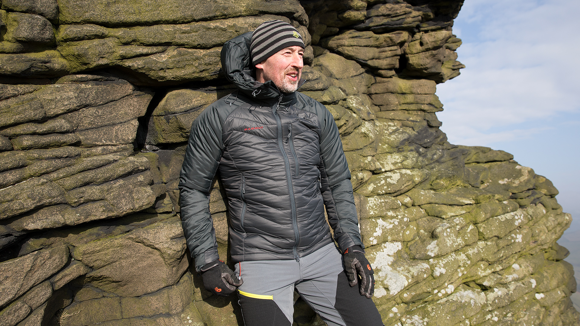 Mammut Rime Pro Hooded Jacket leaning against a gritstone outcrop